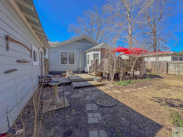 exterior space featuring a wooden deck and fence