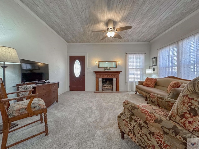 living room featuring a fireplace with raised hearth, wood ceiling, ornamental molding, and carpet flooring