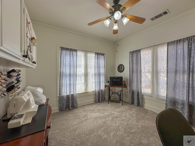 home office featuring visible vents, light carpet, a ceiling fan, crown molding, and baseboards