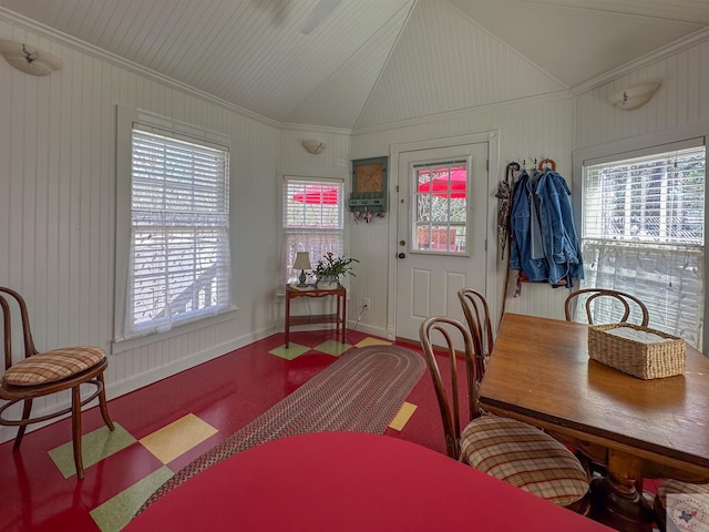 dining area featuring vaulted ceiling and baseboards