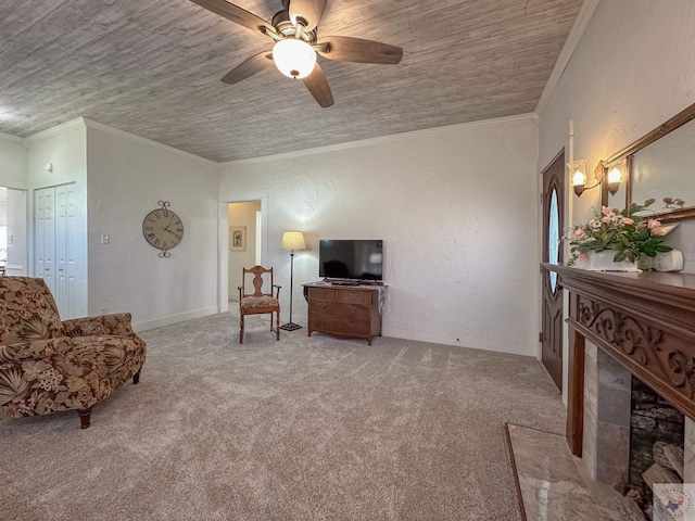 sitting room featuring carpet floors, ornamental molding, and a textured wall