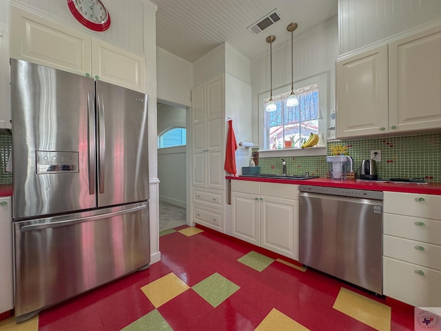 kitchen with white cabinetry, visible vents, a wealth of natural light, and stainless steel appliances