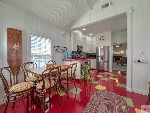 dining area featuring tile patterned floors, visible vents, lofted ceiling, and ceiling fan