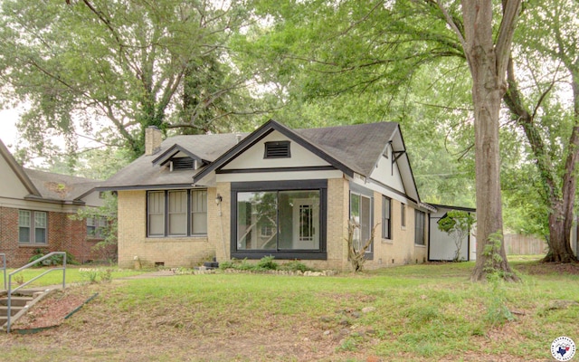 1920 Laurel St, Texarkana, AR 71854 - view of front facade with a chimney, brick siding, a front yard, and crawl space