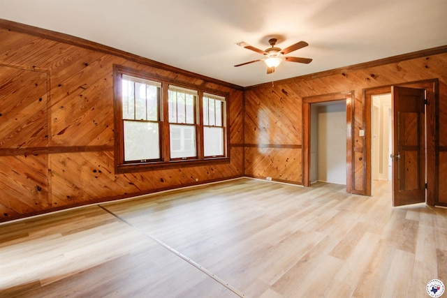 1920 Laurel St, Texarkana, AR 71854 - unfurnished room featuring wooden walls, light wood-style floors, ceiling fan, and baseboards