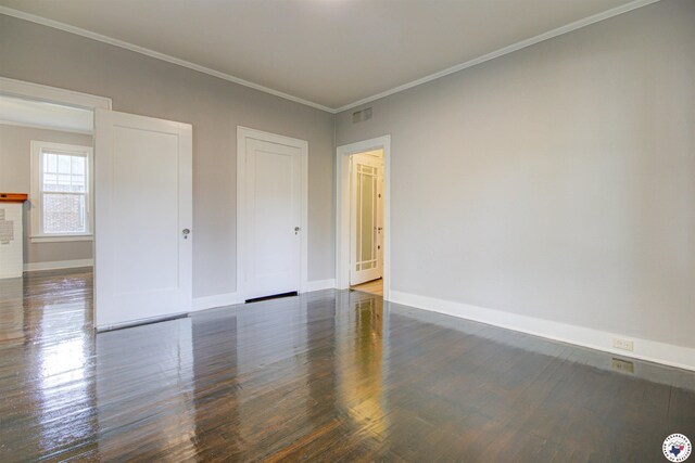 1920 Laurel St, Texarkana, AR 71854 - unfurnished bedroom featuring baseboards, wood finished floors, and ornamental molding