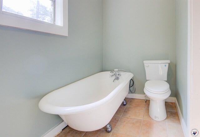 1920 Laurel St, Texarkana, AR 71854 - full bathroom featuring a freestanding tub, toilet, baseboards, and tile patterned floors