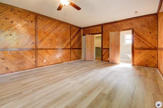 1920 Laurel St, Texarkana, AR 71854 - empty room featuring a ceiling fan, wood walls, and wood finished floors
