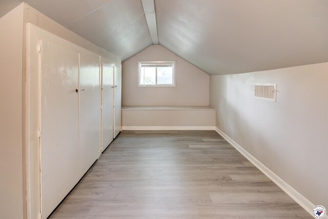1920 Laurel St, Texarkana, AR 71854 - additional living space with lofted ceiling, light wood finished floors, and baseboards