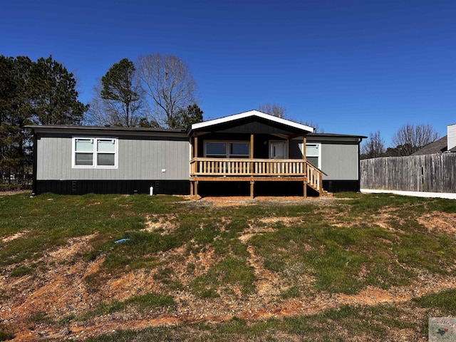 2 Rayn St, Texarkana, TX 75501 - view of front of house featuring fence, a deck, and a front lawn