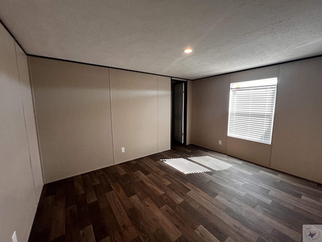 2 Rayn St, Texarkana, TX 75501 - unfurnished bedroom with a closet, dark wood finished floors, and a textured ceiling