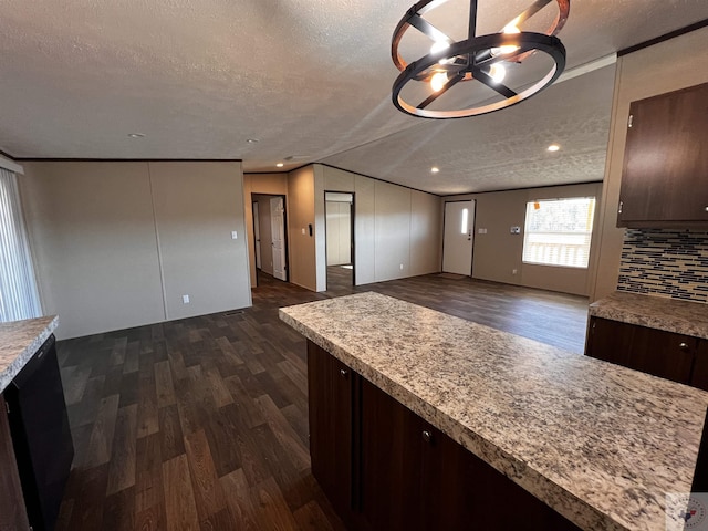 2 Rayn St, Texarkana, TX 75501 - kitchen featuring dark wood-style floors, light countertops, and dark brown cabinets