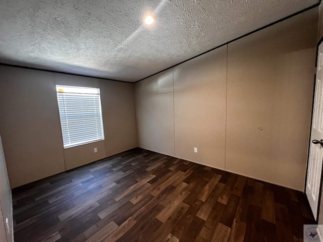2 Rayn St, Texarkana, TX 75501 - spare room with a textured ceiling and dark wood-style flooring
