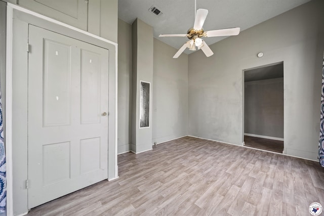 unfurnished bedroom with baseboards, a ceiling fan, light wood-style floors, and visible vents