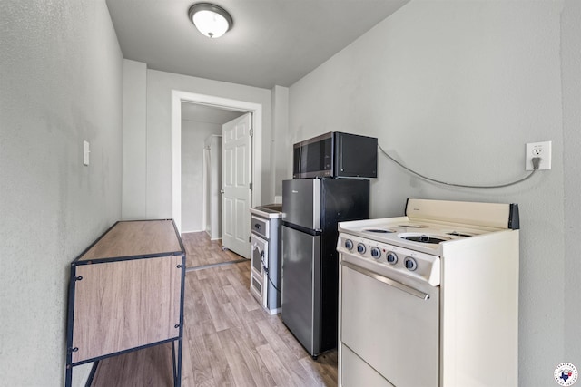 kitchen with appliances with stainless steel finishes and light wood-type flooring