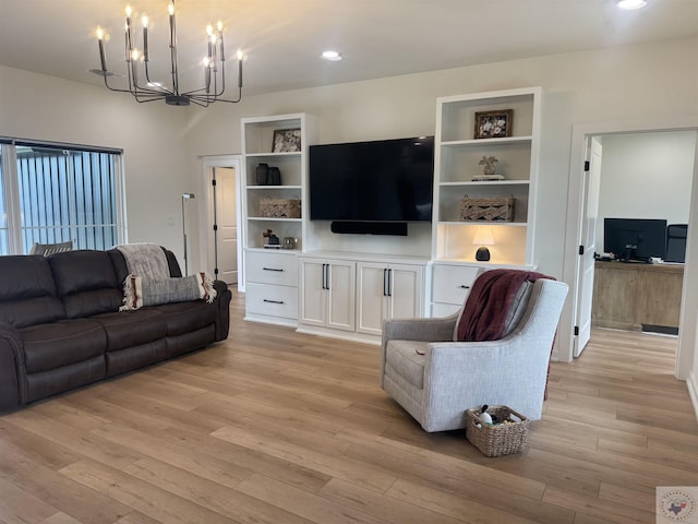 living room with recessed lighting, an inviting chandelier, and light wood-style floors