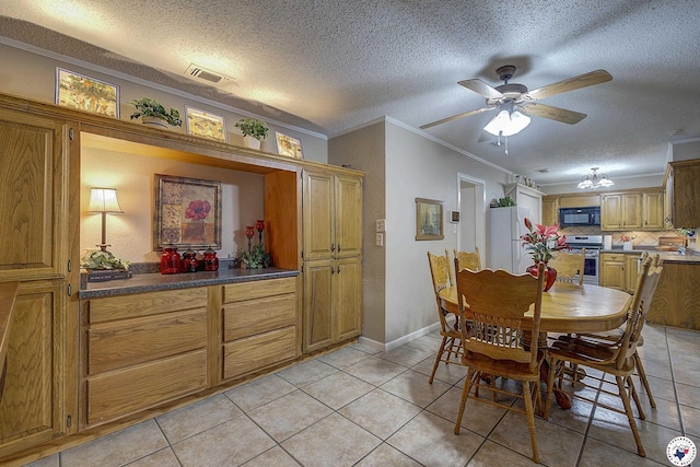3916 Sabine Ave, Texarkana, TX 75503 - dining room with light tile patterned flooring, ceiling fan, ornamental molding, a textured ceiling, and baseboards