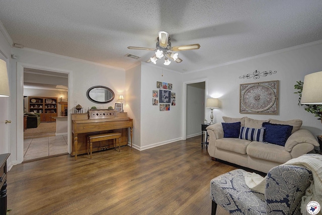 3916 Sabine Ave, Texarkana, TX 75503 - living room with a ceiling fan, wood finished floors, crown molding, a textured ceiling, and baseboards