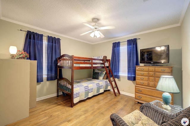 3916 Sabine Ave, Texarkana, TX 75503 - bedroom with wood finished floors, baseboards, a textured ceiling, ornamental molding, and ceiling fan
