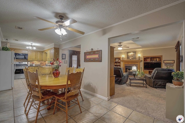 3916 Sabine Ave, Texarkana, TX 75503 - dining space featuring a ceiling fan, light tile patterned flooring, a fireplace, a textured ceiling, and ornamental molding