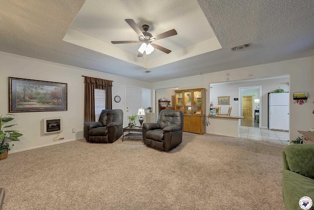 3916 Sabine Ave, Texarkana, TX 75503 - living area featuring light carpet, ceiling fan, a raised ceiling, heating unit, and a textured ceiling
