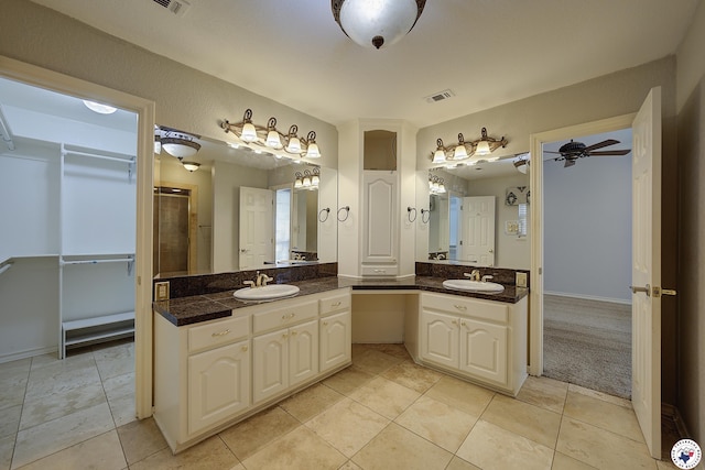 full bathroom with an enclosed shower, visible vents, tile patterned flooring, ceiling fan, and vanity