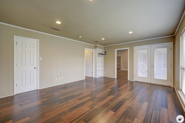 unfurnished bedroom featuring french doors, visible vents, dark wood-type flooring, ornamental molding, and recessed lighting
