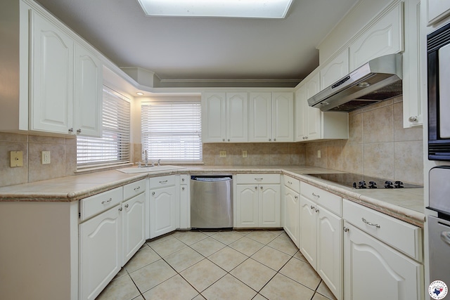 kitchen featuring under cabinet range hood, stainless steel dishwasher, a sink, backsplash, and black electric cooktop