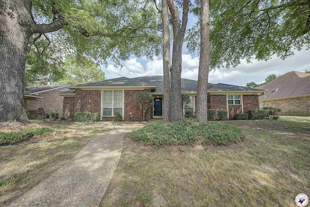 single story home featuring brick siding
