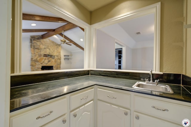 4 Heatherwood Dr, Texarkana, TX 75503 - interior space featuring a fireplace, lofted ceiling with beams, and a sink
