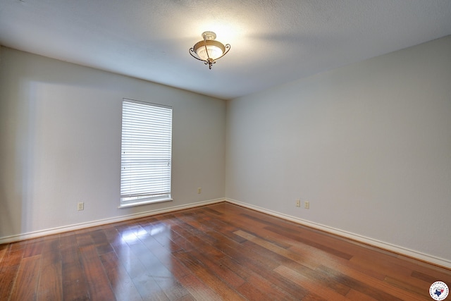 4 Heatherwood Dr, Texarkana, TX 75503 - spare room featuring baseboards and dark wood-style floors
