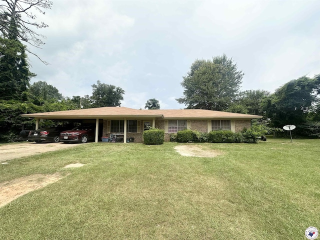 709 Mimosa Ln, Atlanta, TX 75551 - ranch-style home with a front yard, an attached carport, and brick siding