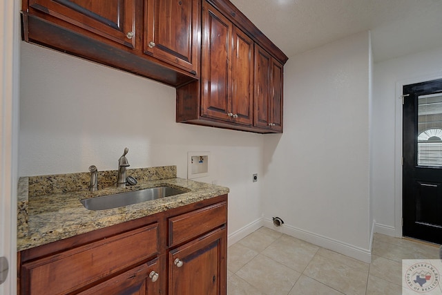 washroom with sink, hookup for a washing machine, electric dryer hookup, cabinets, and light tile patterned flooring