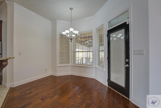 unfurnished dining area featuring crown molding, dark wood-type flooring, and a notable chandelier