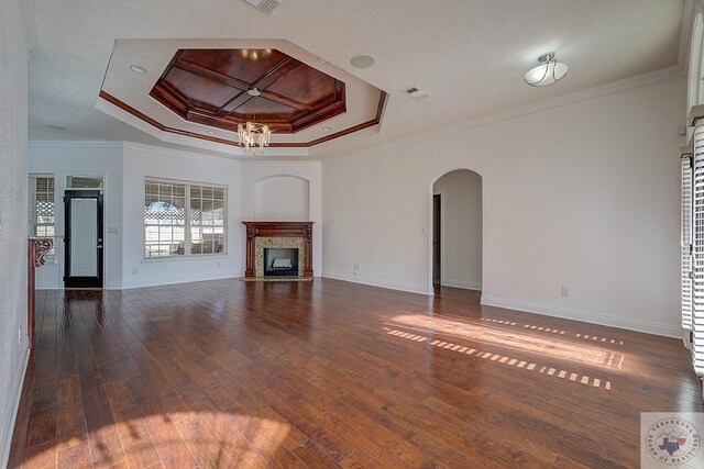 unfurnished living room featuring a raised ceiling, ornamental molding, and a fireplace