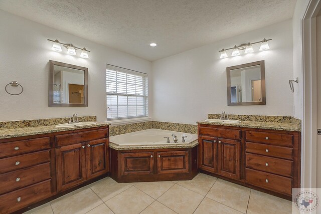 bathroom featuring a textured ceiling, vanity, and tile patterned flooring