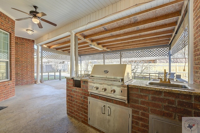 view of patio / terrace featuring sink, ceiling fan, a grill, and area for grilling