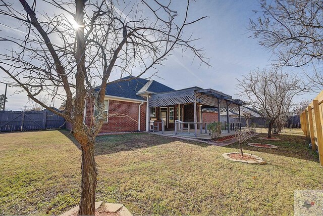 back of property with a patio and a lawn