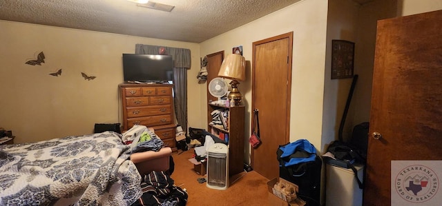 bedroom with light colored carpet and a textured ceiling