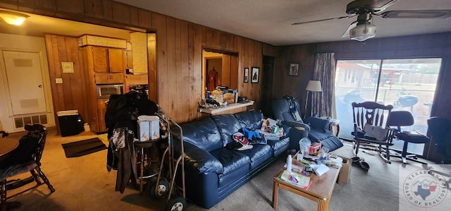 living room with wooden walls and ceiling fan