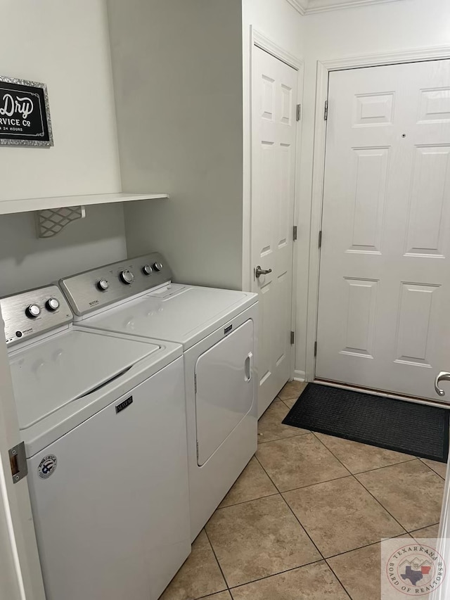 washroom featuring light tile patterned floors and washer and dryer