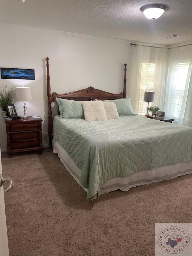 carpeted bedroom with a textured ceiling