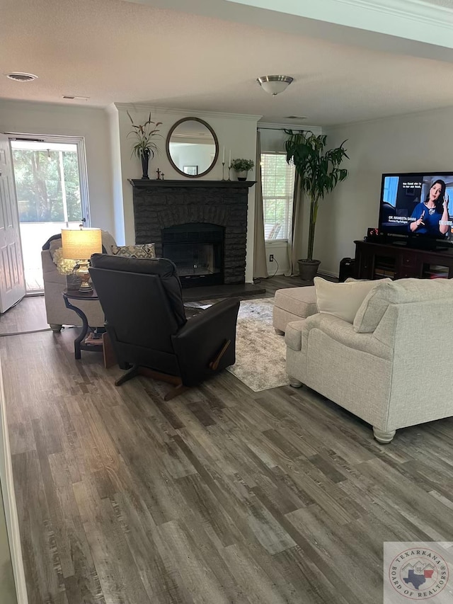 living room with a brick fireplace and hardwood / wood-style floors