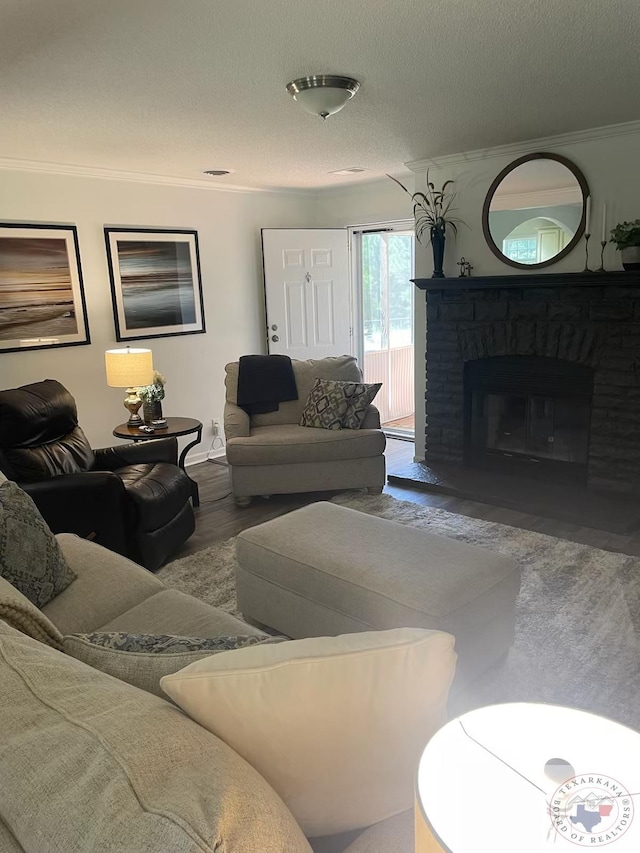 living room with hardwood / wood-style floors, ornamental molding, and a textured ceiling