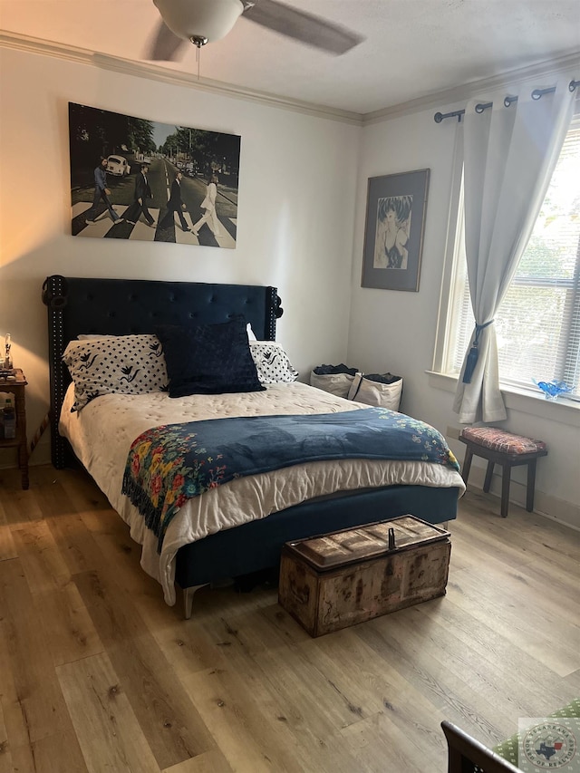 bedroom featuring ceiling fan, hardwood / wood-style floors, and ornamental molding