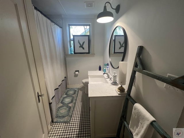 bathroom featuring vanity, toilet, and a shower with shower curtain