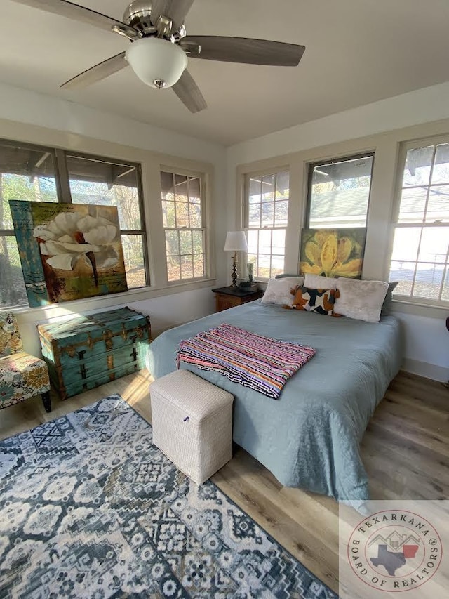 bedroom featuring ceiling fan and hardwood / wood-style floors