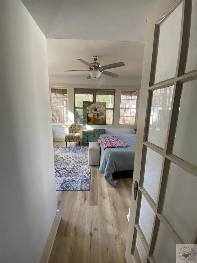 bedroom featuring ceiling fan and light hardwood / wood-style floors