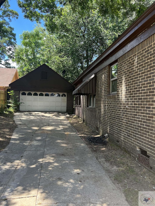 view of home's exterior with an outbuilding and a garage