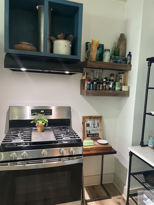 kitchen with extractor fan, light wood-type flooring, and stainless steel range with gas cooktop